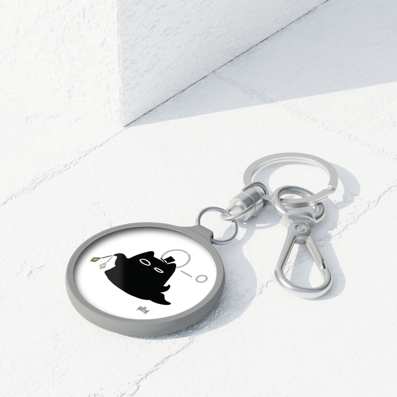 Lord of the Mysteries Cat Keyring - Black cat with monocle design, angled view on marble surface